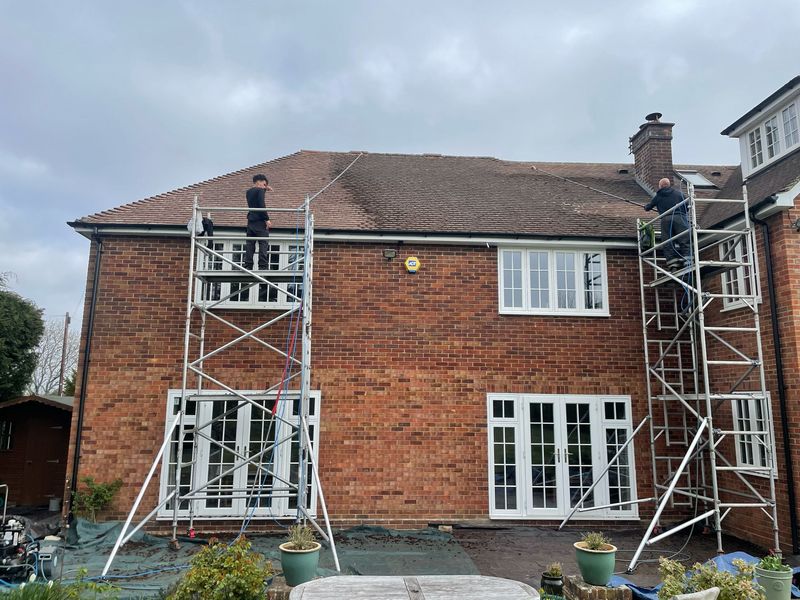 Roof cleaning carried out safely from scaffold towers by The Roof Moss Cleaners in Oxted